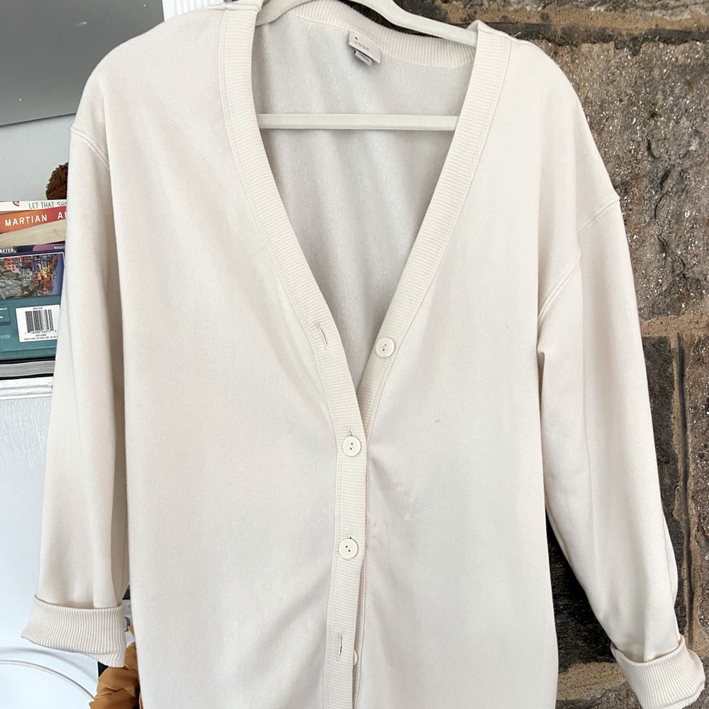 Cream colored cardigan can be worn as an open sweater or buttoned up